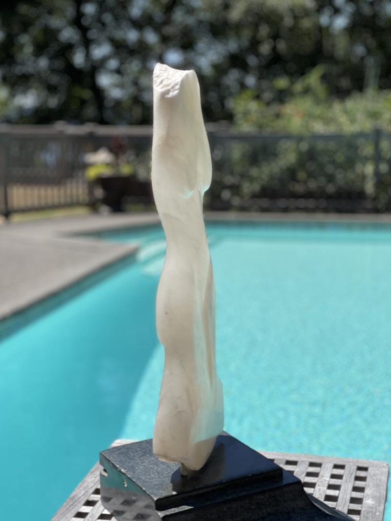 Side. Translucent alabaster lady on a soapstone mounting. Fun fact: alabaster was once used for windows!