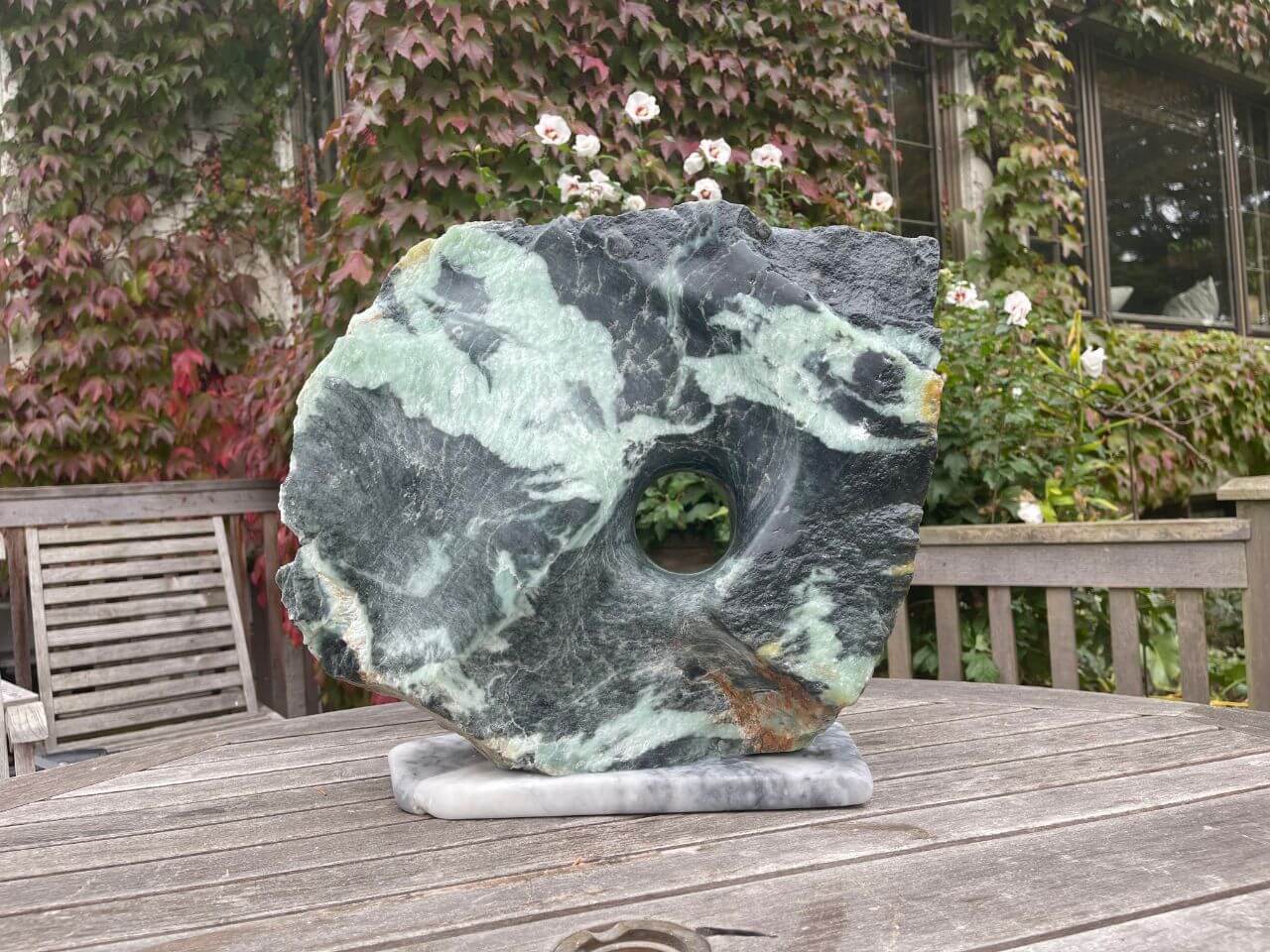 Green and black fusion soapstone. A two sided portal allows for different color and contours on opposite sides