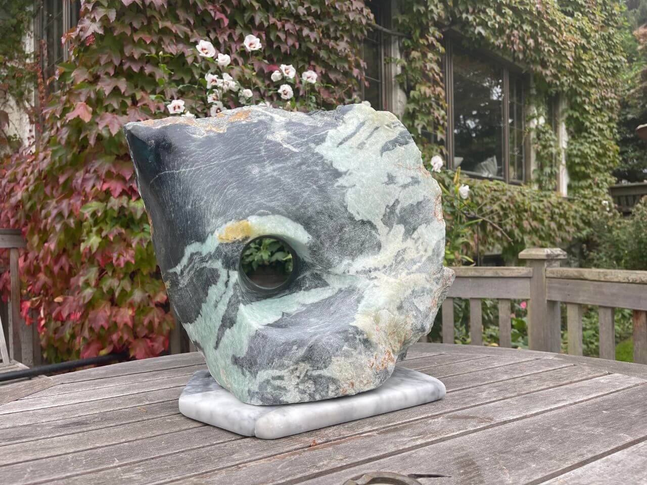 Green and black fusion soapstone. A two sided portal allows for different color and contours on opposite sides