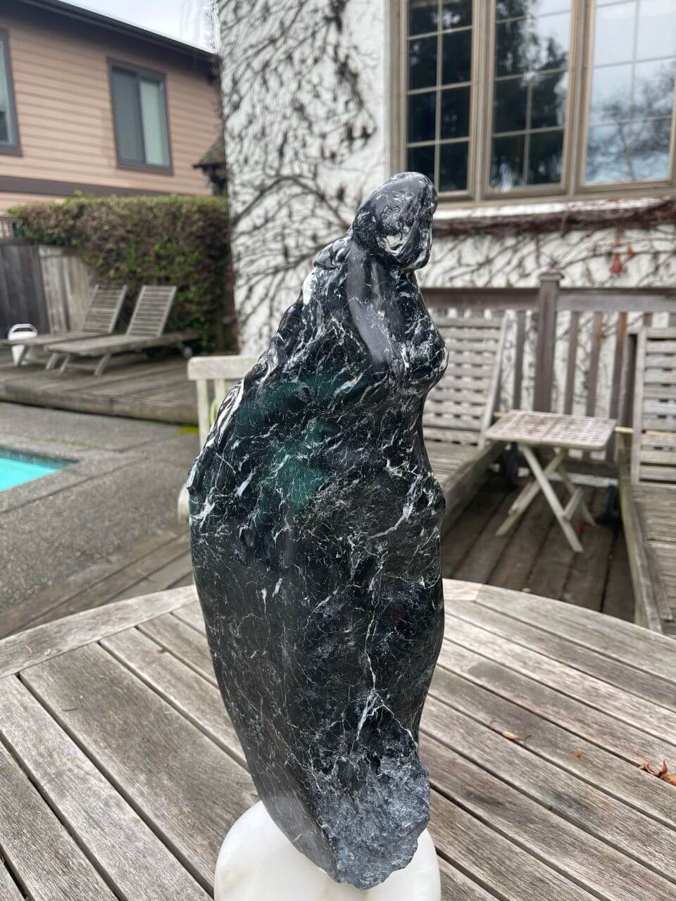Black marble figure of a shawl clad lady, a potential bowspirit if it weren't’ made of stone